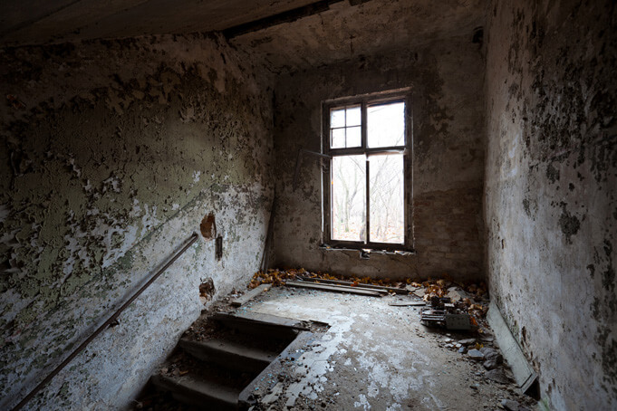 An eerie stairway in one of Berlin's abandoned spaces: the Beelitz-Heilstätten. Source. 