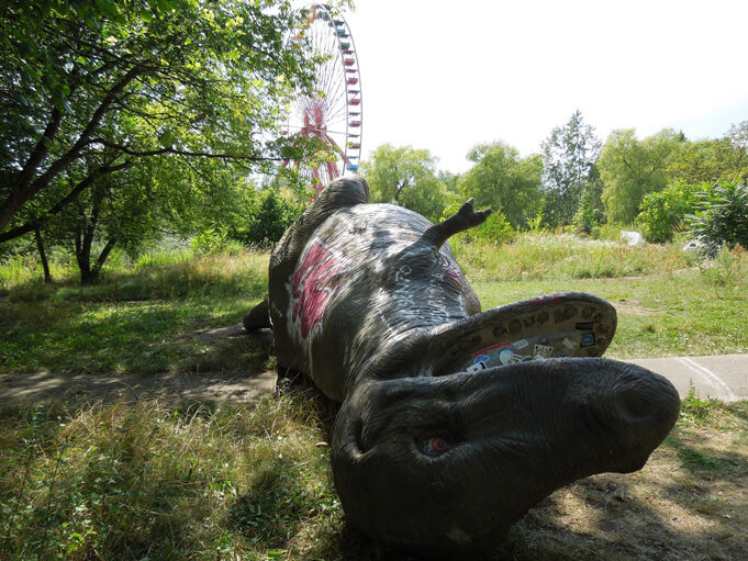 Overturned dinosaurs at Spreepark. Source.